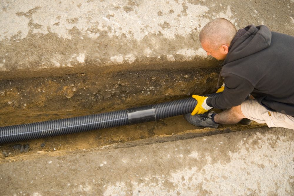 Contractor installing a French drain in a Montreal home