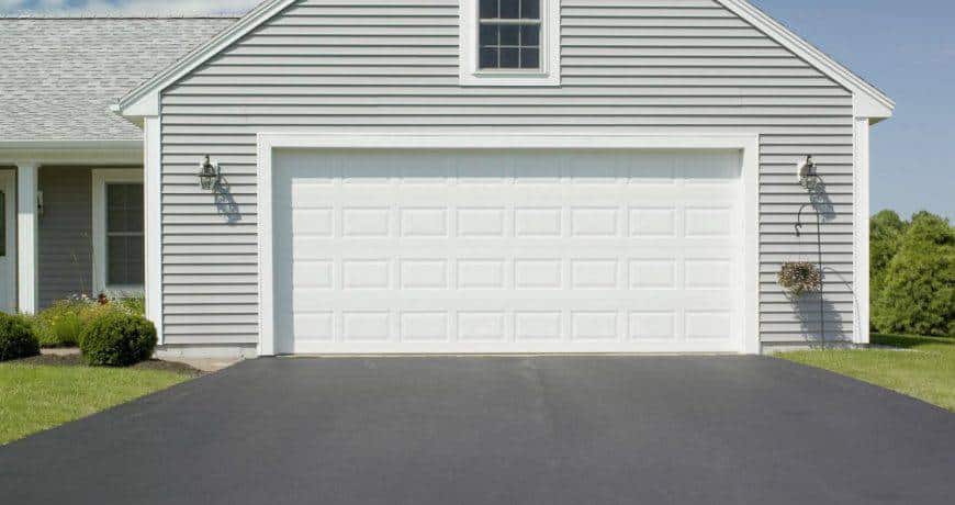 Laying asphalt in front of a residential garage